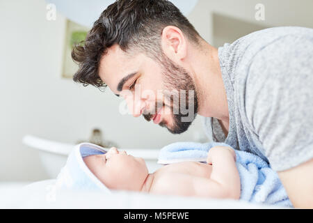 Man as a proud father and newborn baby wrapped in a towel Stock Photo