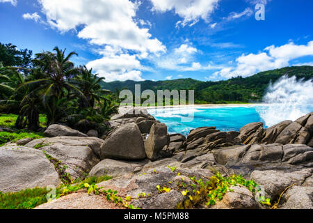 granite rocks at wild tropical beach with palms,white sand and turquoise water, police bay, seychelles Stock Photo