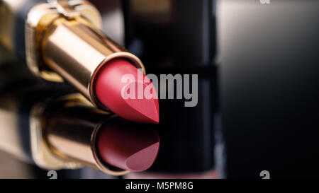 Fashion Colorful Lipsticks over black background with space for text. Lipstick tints palette, Professional Makeup and Beauty. Lipgloss closeup Stock Photo