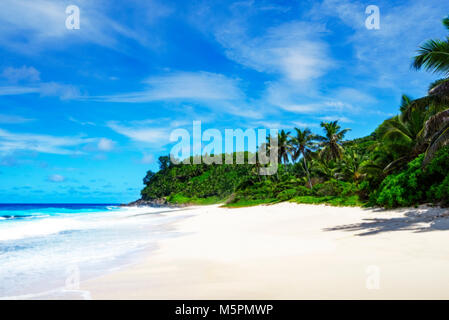 Picturesque beautiful paradise beach anse bazarca on mahé. white sand,turquoise water,palm trees, granite rocks, seychelles Stock Photo