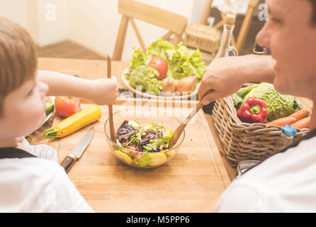 Father is cooking with his son Stock Photo