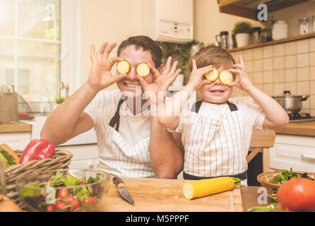 Father is cooking with his son Stock Photo