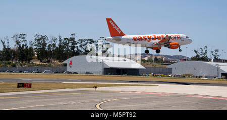 PORTO, PORTUGAL - JULY 19, 2012: An EASYJET aircraft landing at the Francisco Sa Carneiro Airport on July 19, 2012 in Porto, Portugal. Stock Photo