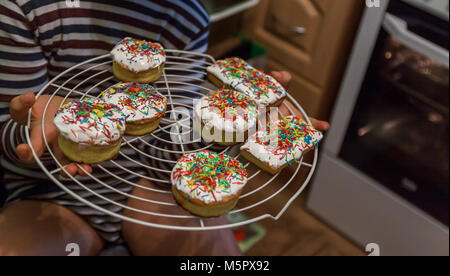 Little Easter cakes in children's hands, life style. Stock Photo