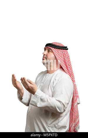 A praying man in traditional Arabic clothes Stock Photo