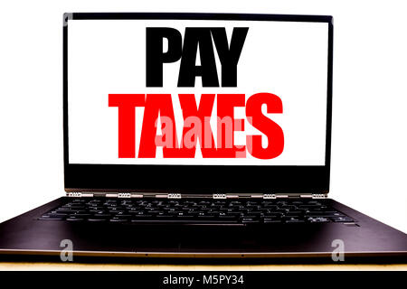 Handwritten text showing Pay Taxes. Business concept writing for Taxation Overtax Return Written on monitor front screen, white background with space  Stock Photo