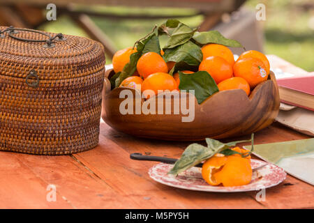 Wooden bowl of tangerines on a outside table Stock Photo