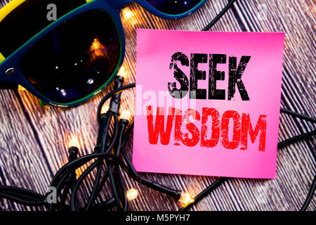 Hand writing text caption showing Seek Wisdom. Business concept for Inspiration Knowledge written on the wood with sunglasses copy space Stock Photo
