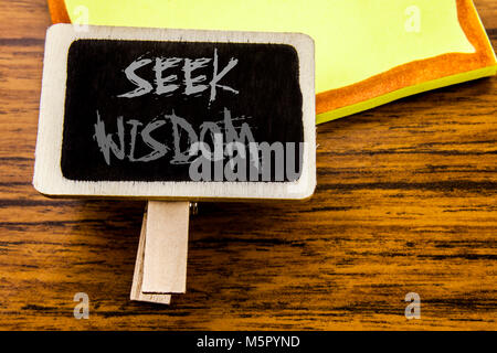 Handwritten text showing Seek Wisdom. Business concept for Inspiration Knowledge written on announcement board on wooden wood background. Stock Photo