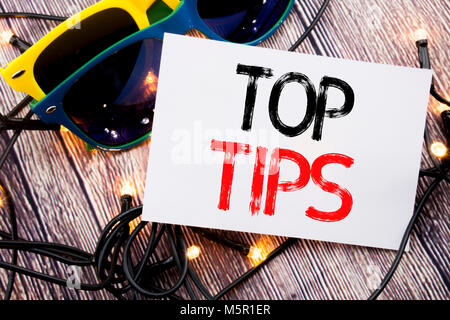 Writing text showing Top Tips. Business concept for Expert Tip Guidance written on old wood wooden background with sunglasses Stock Photo
