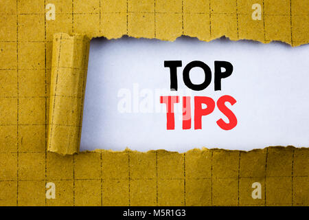 Top Tips. Business concept for Expert Tip Guidance written on white paper on yellow folded paper. Stock Photo