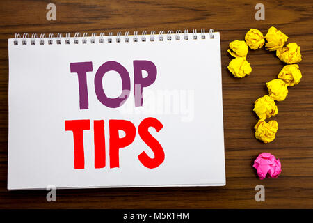 Conceptual hand writing caption inspiration showing Top Tips. Business concept for Expert Tip Guidance written on notepad paper on the wooden backgrou Stock Photo
