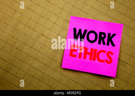 Handwritten text caption showing Work Ethics. Business concept writing for Moral Benefit Principles written on sticky note paper on yellow background. Stock Photo