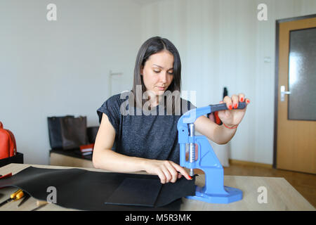 Student learning to sew zipper on purse. Stock Photo