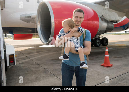 Father and child boarding on plane in airport Stock Photo