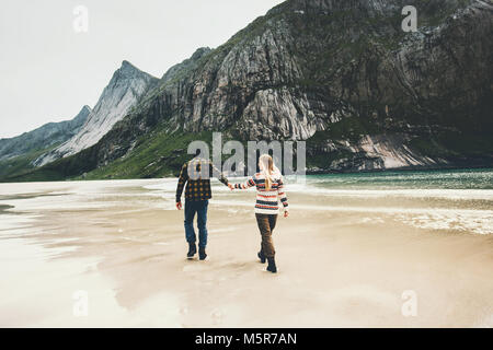 Romantic Couple in love walking holding hands on beach sea man and woman together traveling Lifestyle concept vacations outdoor Stock Photo