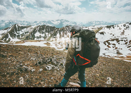 Man traveler with big backpack hiking in mountains expedition Travel survival lifestyle concept adventure outdoor active vacations Stock Photo