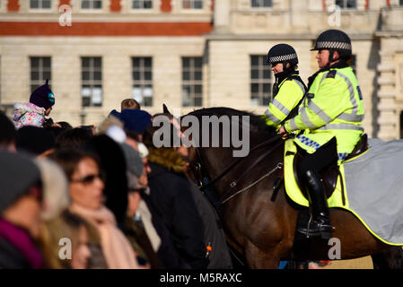 Mounted Metropolitan police female officers Horse Guards Parade, London watching over members of the public during changing of the guard. Young girl Stock Photo