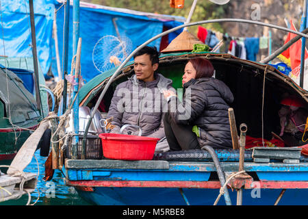 A Vietnamese family prepare meals on their house boat in the Cua Van floating village, Halong Bay, Vietnam Stock Photo