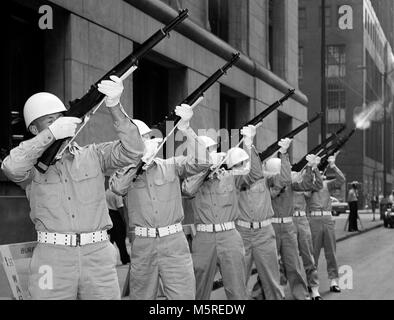 The US Army 3rd division of the 5th Army fires off a  21 gun salute to their war dead in front of Chicago City Hall on LaSalle Street in downtown Chicago in 1957. Stock Photo