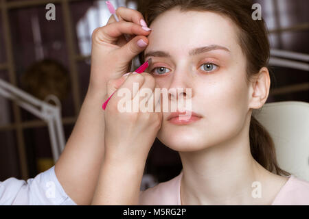 Permanent microblasting tattooing freckles to a woman in a beauty salon Stock Photo