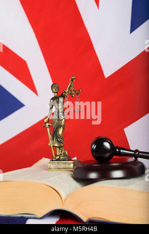 Statue  Themis on a flag of Great Britain. Judge's gavel in the background Stock Photo