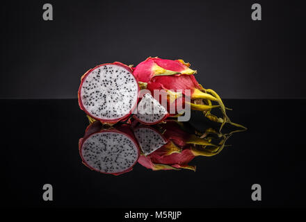Whole and half dragon fruits (pitahaya) on clipping path black background Stock Photo