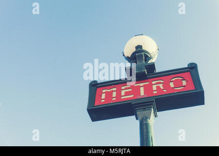 Traditional Paris metro sign against a clar blue sky Stock Photo