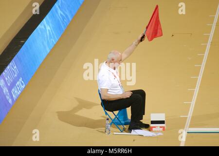 Glasgow, Scotland, 25 February 2018. An athletics official raising the red flag after a long jumper overstepped the line at the Muller Indoor Grand Prix in Glasgow. Credit: Colin Edwards/Alamy Live News. Stock Photo