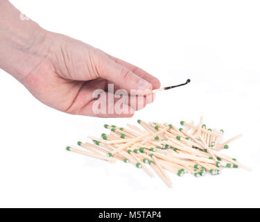 Young woman holding match stick over sulfur free matches separated on white background Stock Photo