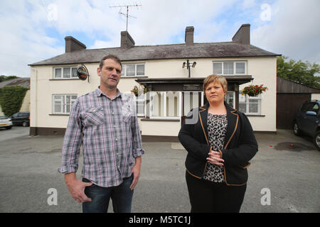 Aidan O'Toole a  survivor of the 1994 gun attack, and Emma Rogan the daughter of Adrian Rogan a victim who was murdered by Loyalist gunmen in 1994 attack stands outside the Bar, as it is today. (2 Oct 2012). O'Tooles Bar is the only Pub in the small village of Loughinisland in County Down, Northern Ireland. On 18 June 1994 and The Ulster Volunteer Force (UVF), a loyalist paramilitary group, attacked the crowded pub with assault rifles killing six civilians and wounding five. The pub was targeted because those inside were believed to be C Stock Photo