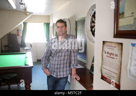 Aidan O'Toole a  survivor of the 1994 gun attack by Loyalist gunmen in 1994 attack stand inside the same room where the gun attack took place in the Bar as it is today. (2 Oct 2012). Aidan O'Toole stands in the same spot where he was on the night of the gun attack. Once the main Bar area, today, the room has been turned into a loung and pool room.  O'Tooles Bar is the only Bar in the small village of Loughinisland in County Down, Northern Ireland. On 18 June 1994 and The Ulster Volunteer Force (UVF), a loyalist paramilitary group, attack Stock Photo