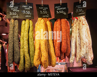 Several Fuet sauseges on the La Boqueria Market in Barcelona. Fuet is a Catalan thin, dry cured, sausage. Stock Photo