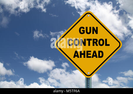 Gun control ahead road sign against blue cloudy sky Stock Photo