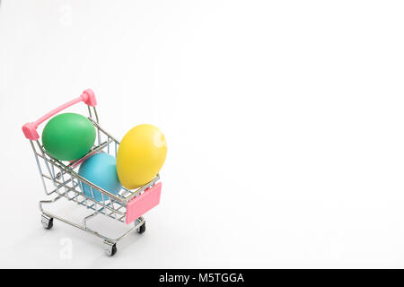 Dyed eggs in a shopping cart, perfect Easter sale, deal, promotional background Stock Photo