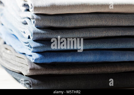 Stack of jeans in different colors. Stock Photo