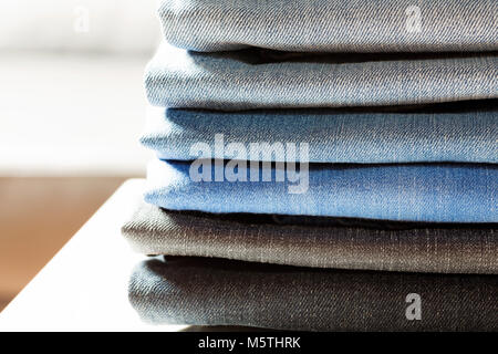 Stack of jeans in different colors. Stock Photo