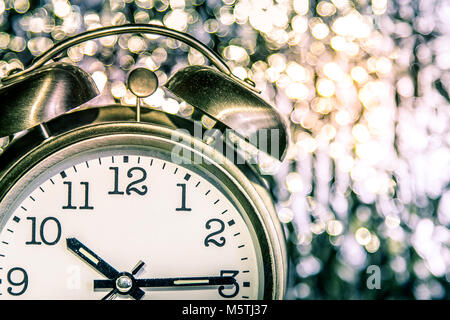 Alarm clock on sparkling background. Stock Photo