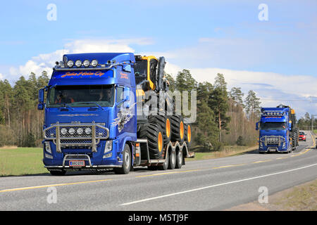 KAARINA, FINLAND - MAY 2, 2014: Two Volvo FH trucks haul Ponsse forest machinery along highway 40. According to recent Q1 2015, Ponsses net sales amou Stock Photo
