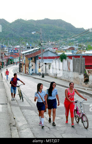 Students wearing blue uniform walking home from school / university, Baracoa, Guantánamo Province, Cuba Stock Photo