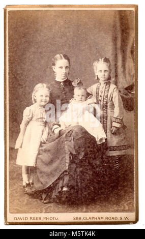 Sarah Jupp (born Sarah Stringer, 1843) with her children Fanny A Jupp (Cis), (born 1871), Ethel Margaret Jupp (born 1874) and baby Constance Jupp (born 1877).  Formal studio family portrait, circa 1878 Stock Photo