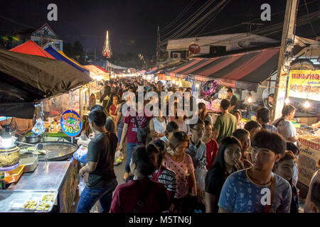 SAMUT PRAKAN, THAILAND, NOV 18 2017, People walk in the aisle between kiosks at Phra Samut Chedi festival.Crowd in the night market. Stock Photo