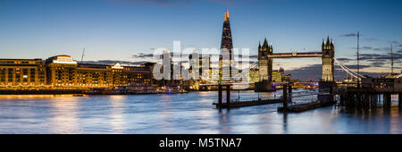 Panoramic view of the London Skyline at Dusk, featuring Tower Bridge, The Shard, Butlers Wharf and the River Thames