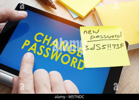 Man holding tablet with words change password from weak to strong. Stock Photo