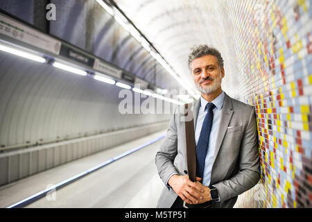 Mature businessman waiting on a metro station. Stock Photo