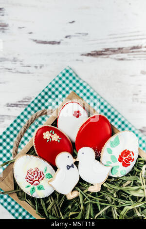 Beautiful glazed easter gingerbread cookies eggs on wooden table. Greeting card. View from above.Copy space. Stock Photo