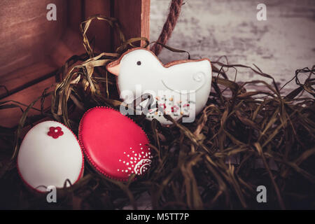 Beautiful glazed easter gingerbread cookies eggs on wooden table. Greeting card. View from above.Copy space. Stock Photo