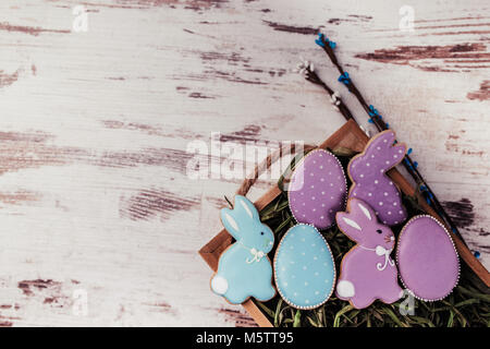 Easter gingerbread cookies on wooden table. Rabbits and eggs. Greeting card. View from above.Copy space. Stock Photo