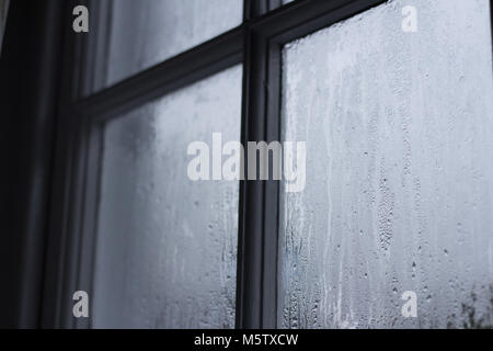 condensation on old wooden frame window in cornish cottage Stock Photo