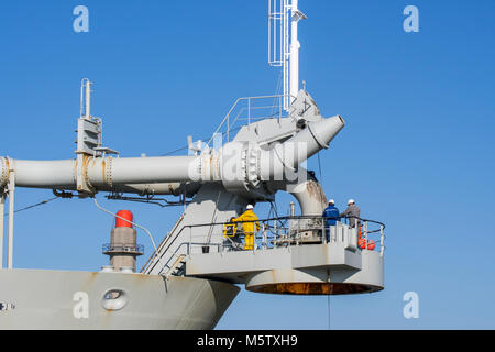 Workers on bow connection platform of trailing suction hopper dredger Alexander von Humboldt from Dredging and Marine Works Jan De Nul Stock Photo